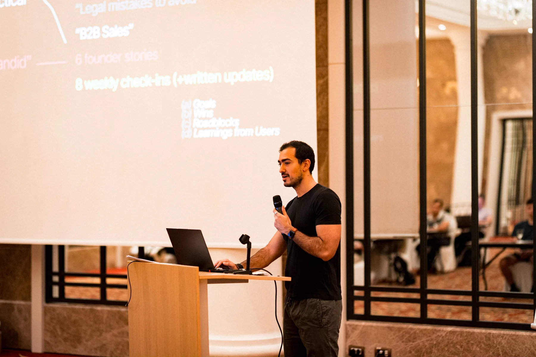 Speaker presenting on stage at a business conference in Barcelona